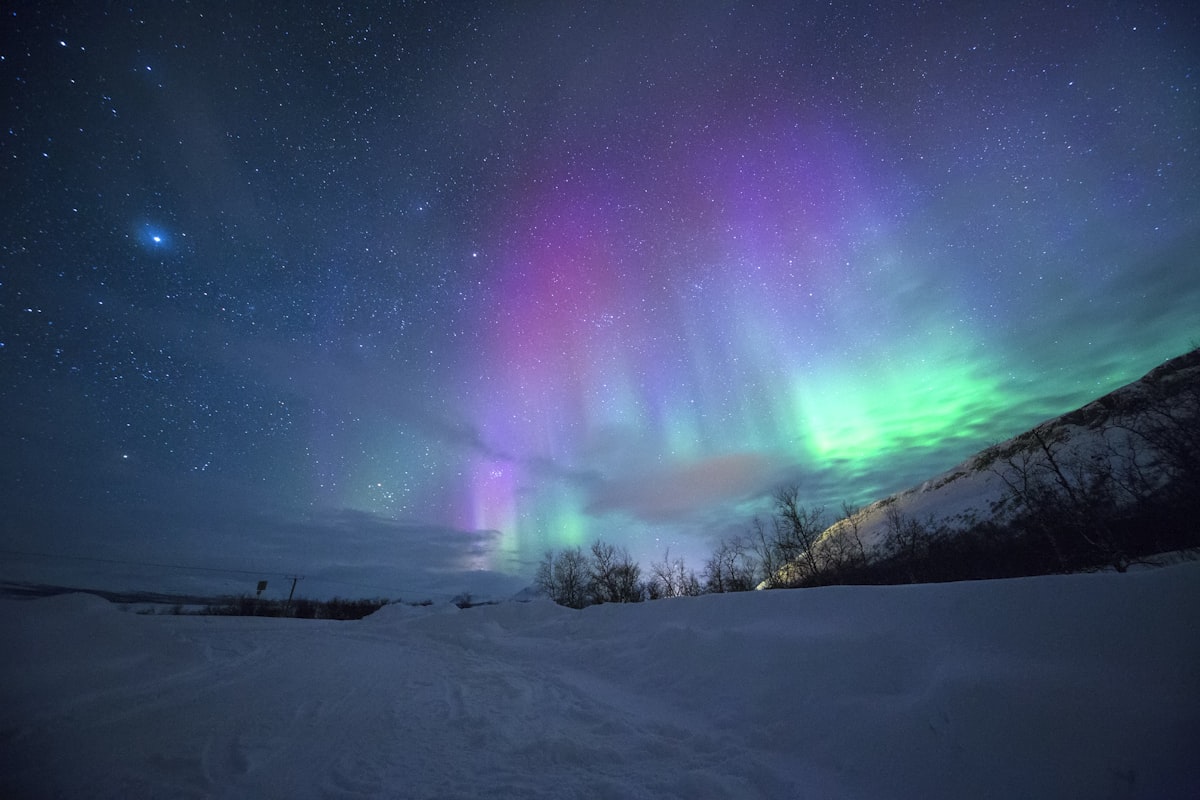 Northern lights over a snowy Icelandic landscape